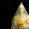 An Oscar statue stands covered with plastic during preparations leading up to the 87th Academy Awards in Hollywood, California