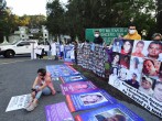 Relatives of missing people take part in a protest outside the 26-A Military Camp, where Mexico's President Andres Manuel Lopez Obrador holds a news conference, in El Lencero