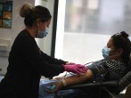 A woman donates blood amid the coronavirus disease (COVID-19) outbreak, in Los Angeles