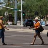 People cross the street between Kierland Commons and Scottsdale Quarter with and without face coverings, during the global outbreak of the coronavirus disease (COVID-19), in Scottsdale