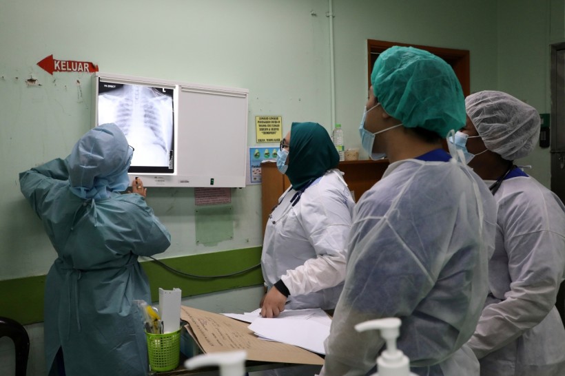 Health workers look at x-rays of a patient at Emergency Department in the Kuala Lumpur Hospital, amid the coronavirus disease (COVID-19) outbreak, in Kuala Lumpur