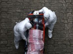 Medical staff, wearing protective gear, move a patient infected with the coronavirus (COVID-19) from an ambulance to a hospital 