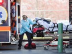 First responders load a patient into an ambulance from a nursing home where multiple people have contracted COID-19 on April 17, 2020 in Chelsea, Massachusetts. Chelsea has the highest concentration o