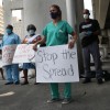 Volunteers, health care workers and doctors participate in a protest against what they say is the city's and county's poor response to helping the homeless during the coronavirus outbreak on April 17, 2020 in Miami, Florida.