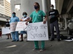 Volunteers, health care workers and doctors participate in a protest against what they say is the city's and county's poor response to helping the homeless during the coronavirus outbreak on April 17, 2020 in Miami, Florida.