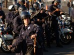 Riot police throw stun grenades and shoot rubber bullets at anti-war protesters 