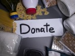 Donate sign handwritten with black letters.