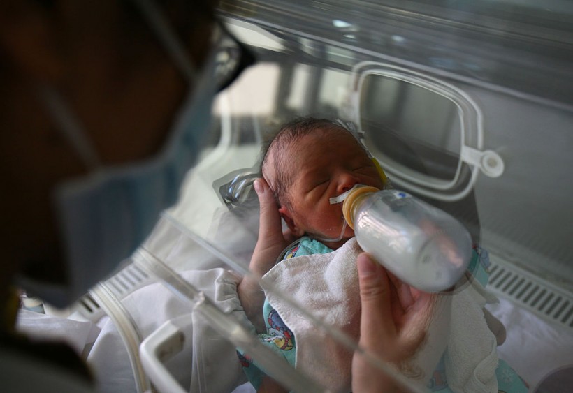 A newborn baby drinks milk at the ICU of Obstetrics and Gynecology Department 