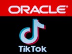 Smartphone with Tik Tok logo is seen in front of displayed Oracle logo in this illustration taken