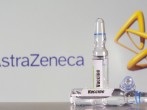 FILE PHOTO: A test tube labelled with the vaccine is seen in front of AstraZeneca logo in this illustration taken