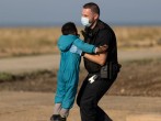 migrant child picked up by border agent