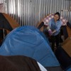 Asylum seeker waits in  Migrant Encampment