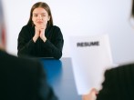 Woman in Black Long Sleeve Shirt Sitting Having Interview