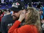 Taylor Swift guards herself from any would-be lip-readers while whispering into the ear of boyfriend Travis Kelce last month