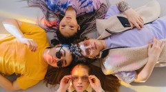 A Group of People Wearing Colorful Clothes Lying on their Backs
