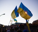 a group of people holding flags in front of a building