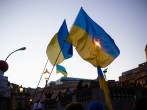 a group of people holding flags in front of a building