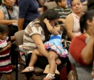 Wendy Nunez, originally from Honduras, holds her daughter, Gianella Hernandez, as she attends an Immigration Field Hearing held by U.S. Rep Joe Garcia (D-FL) and Rep. Ted Deutch (D-FL) at Broward College on August 13, 2014 in Fort Lauderdale, Florida. 