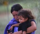 A Guatemalan Immigrant Crosses the Border with her Child