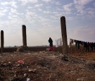 A Syrian woman hangs laundry in Majdal Anjar, Lebanon