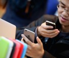 A man uses an iPhone 6 at the Apple Store