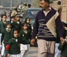 A man leads school children to safety following the attack