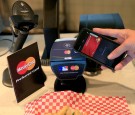 A shopper uses MasterCard with Apple Pay