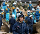 Japanese police survey crime scene.