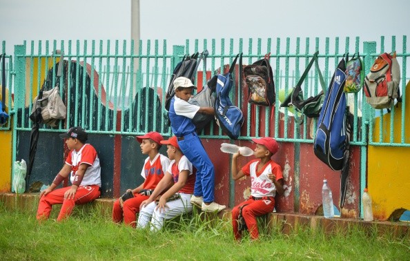 Kids Resting After Playing Baseball in Cuba