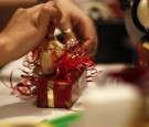 A shopping mall employee gift-wraps a perfume in Frankfurt in this November 28, 2009 file photo.