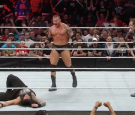 Randy Orton standing tall after delivering an RKO on Roman Reigns on 