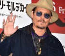 TOKYO, JAPAN - JANUARY 28: Johnny Depp waves at the photo call for 'Mortdecai' at The Peninsula Tokyo on January 28, 2015 in Tokyo, Japan.