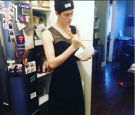 Rain Dove, an Androgynous model takes a snapshot of herself in her kitchen.