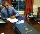 President Obama Signs Bills In The Oval Office Of White House