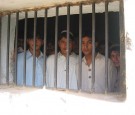 Youth look out from a Pakistani jail.